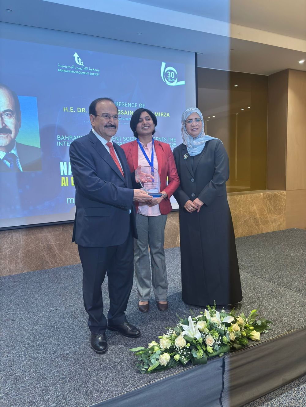 Harsha Sreehari receiving an honour from H.E. Dr. Abdulhussain bin Ali Mirza at the International Leadership Conference 2025